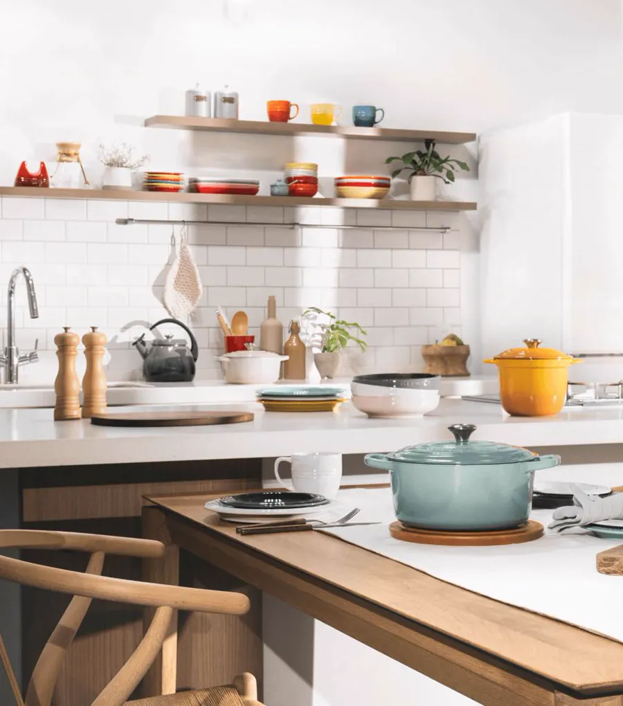 Modern kitchen with a turquoise enameled pot on the table